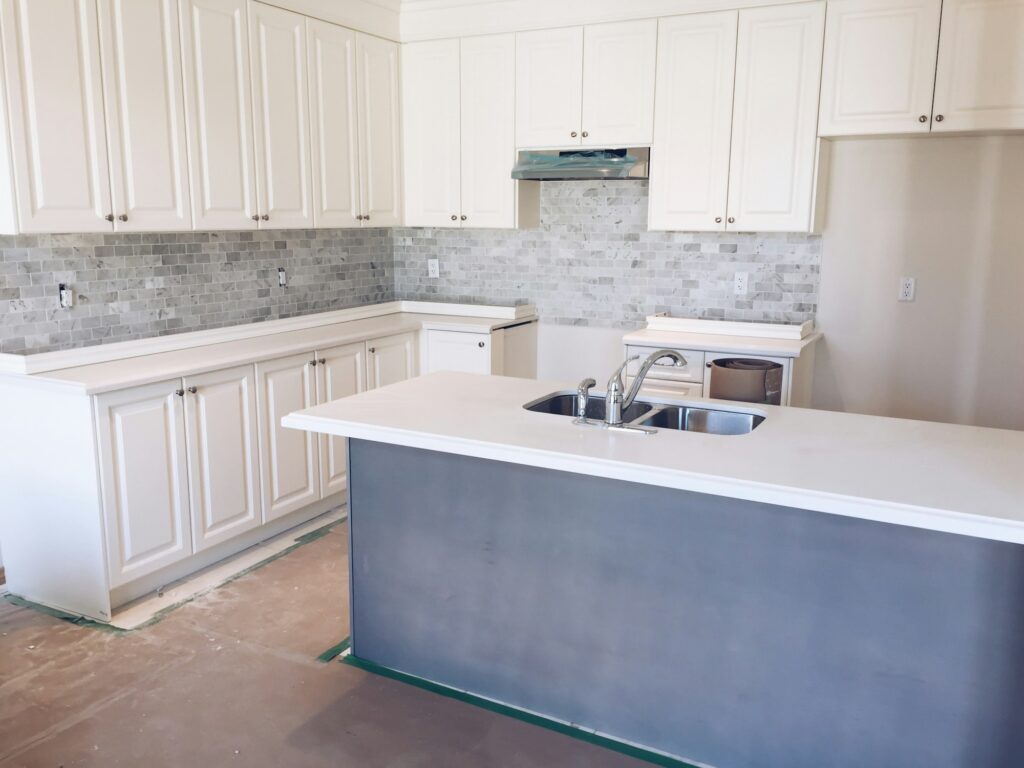 New bright modern kitchen with an island being installed